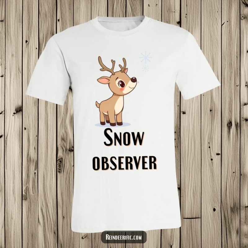 Funny t-shirt depicting a curious reindeer tilting its head, intently watching a delicate snowflake descend.